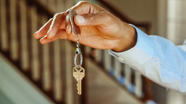 person-holding-hanging-keys person-holding-hanging-keys